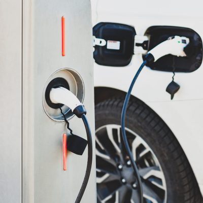 The electric car charger plugged in to the socket.The modern electric car charging the battery.
